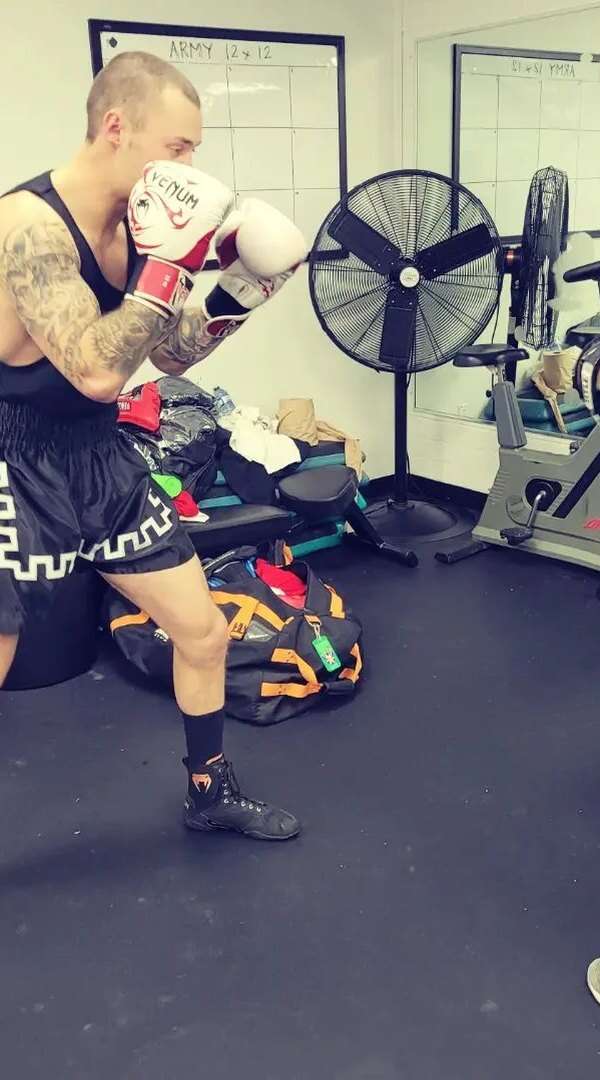 Pad work with a coach in an adult boxing class