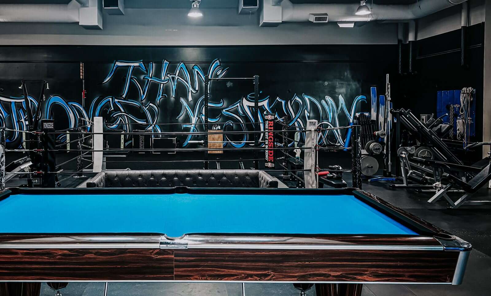 The blue wildstyle mural behind the boxing ring