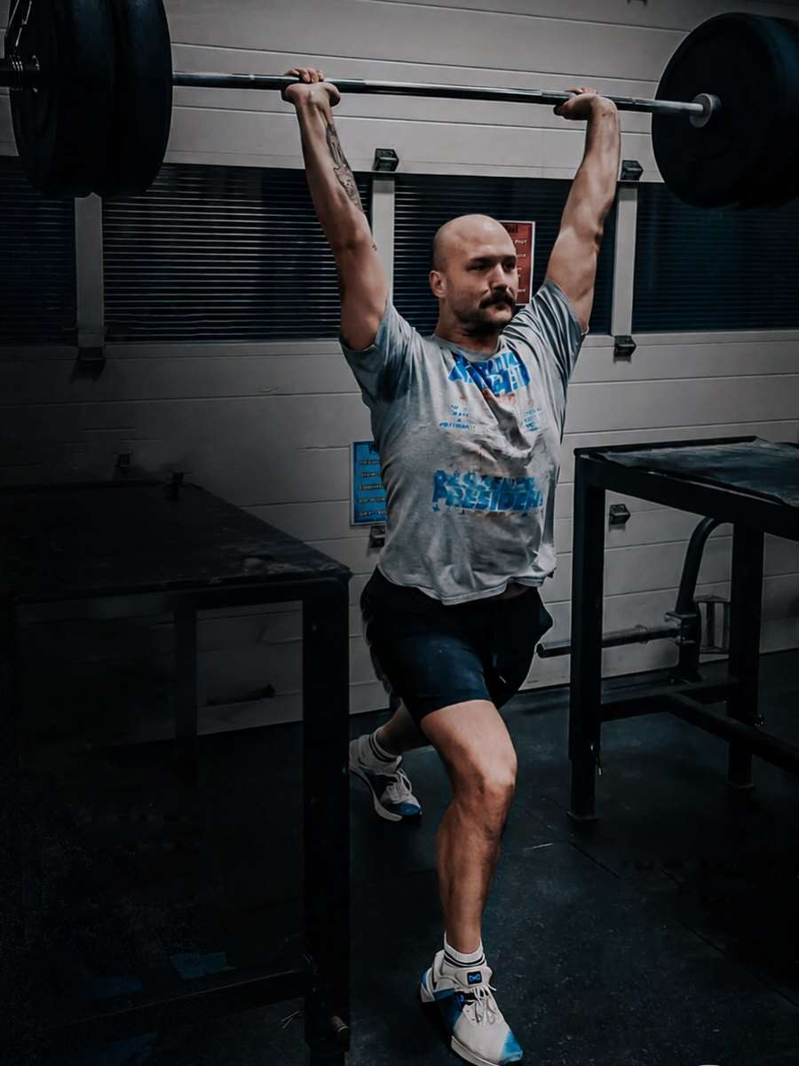 Ryan Doll pressing a barbell overhead